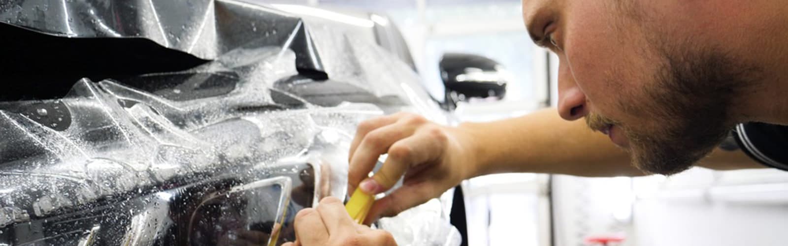 man trying to repair dent on the car in ibiza